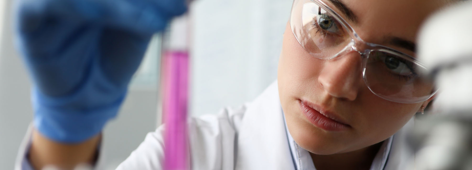 Medical pro observing fluid in tube - AI Solutions in Healthcare | DXC Technology Insights