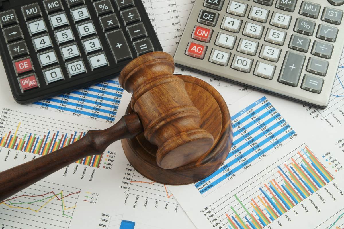 Gavel on spreadsheet with calculators, Assure Legal Solutions | DXC Technology